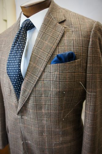 Bhambi's master tailor hand-sewing a bespoke suit in the New York City workshop – custom menswear crafted in Midtown Manhattan